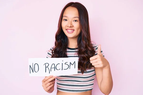 Young Beautiful Chinese Girl Holding Racism Banner Smiling Happy Positive — Stock Photo, Image