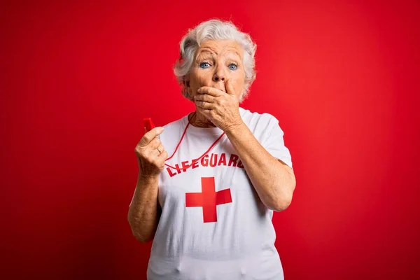 Starsza Piękna Siwowłosa Ratowniczka Nosząca Koszulkę Czerwonym Krzyżem Używająca Gwizdka — Zdjęcie stockowe