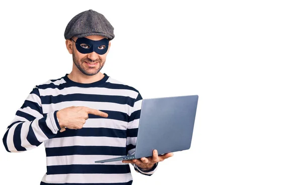 Ung Stilig Man Bär Inbrottstjuv Mask Med Bärbar Dator Ler — Stockfoto