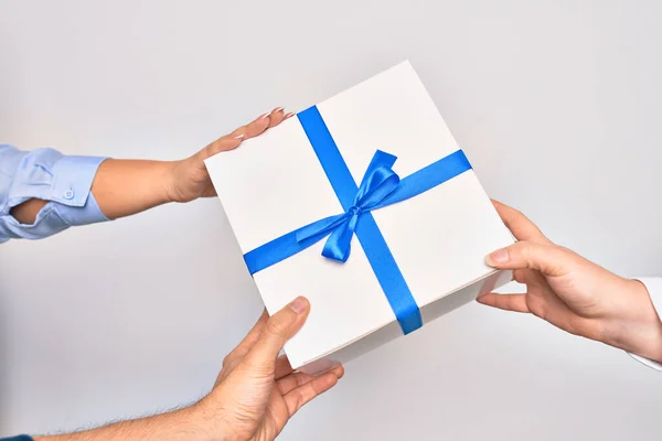 Three hands holding birthday gift over isolated white background