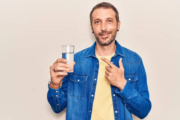 Jonge Knappe Man Drinkt Glas Water Glimlachend Vrolijk Wijzend Met — Stockfoto