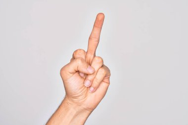 Hand of caucasian young man showing fingers over isolated white background showing provocative and rude gesture doing fuck you symbol with middle finger