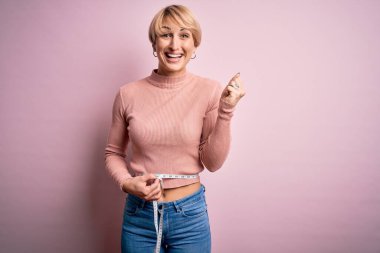 Kısa saçlı, kısa boylu, zayıf bir kadın. Ölçüm bandı kullanarak gururla bağırıyor, zaferi ve başarıyı kutluyor. Çok heyecanlı, coşkulu bir duygu.