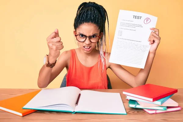 Young african american girl child with braids showing failed exam annoyed and frustrated shouting with anger, yelling crazy with anger and hand raised