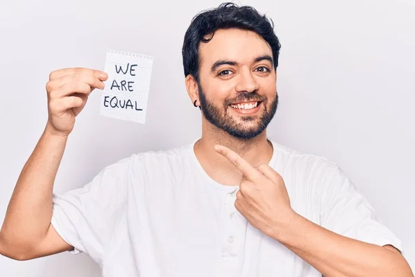 Young Hispanic Man Holding Equal Paper Smiling Happy Pointing Hand — Stock Photo, Image