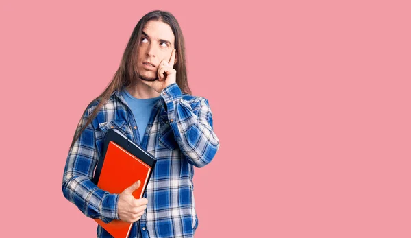 Young Adult Man Long Hair Holding Collage Book Serious Face — Stock Photo, Image