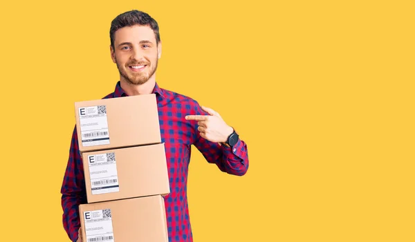 Handsome Young Man Bear Holding Delivery Packages Pointing Finger One — Stock Photo, Image