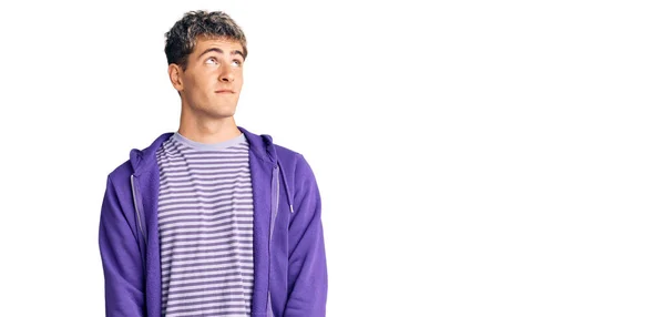 Young Handsome Man Wearing Casual Purple Sweatshirt Smiling Looking Side — Stock Photo, Image