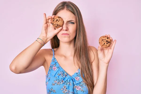 Menina Loira Segurando Biscoito Cético Nervoso Franzindo Testa Chateado Por — Fotografia de Stock