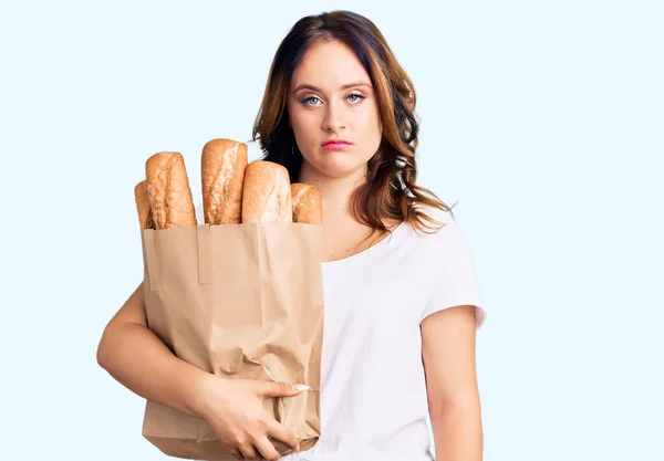 Young Beautiful Caucasian Woman Holding Paper Bag Bread Thinking Attitude — Stock Photo, Image