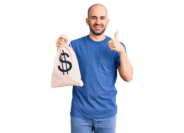 Jovem Homem Bonito Segurando Saco Dinheiro Com Símbolo Dólar Sorrindo — Fotografia de Stock