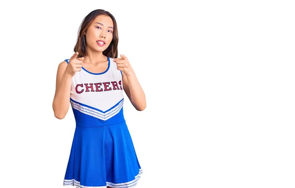 Young Beautiful Chinese Girl Wearing Cheerleader Uniform Pointing Fingers Camera — Stock Photo, Image