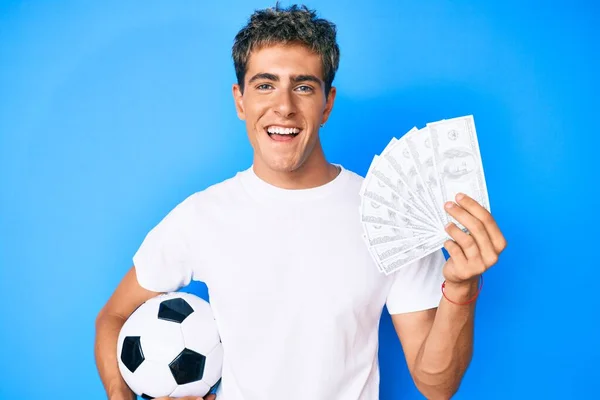 Joven Hombre Guapo Sosteniendo Pelota Fútbol Billetes Dólares Sonriendo Riendo —  Fotos de Stock