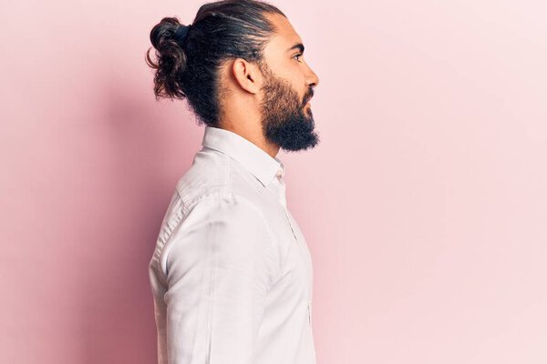 Young arab man wearing casual clothes looking to side, relax profile pose with natural face with confident smile. 