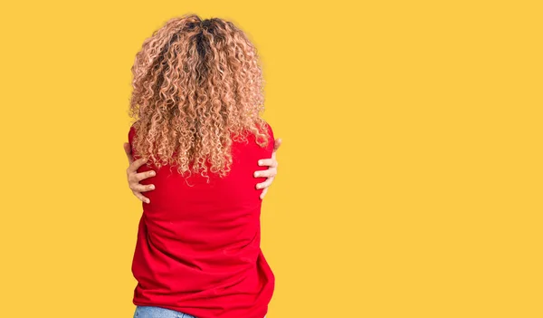 Mladá Blondýnka Kudrnatými Vlasy Oblečená Neformálním Červeném Tričku Šťastně Objímající — Stock fotografie