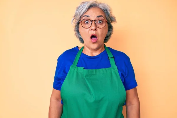 Senior Hispanic Woman Wearing Apron Glasses Scared Amazed Open Mouth — Stock Photo, Image