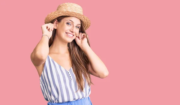 Young Beautiful Blonde Woman Wearing Summer Hat Smiling Pulling Ears — Stock Photo, Image