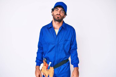 Kıvırcık saçlı ve ayı gibi giyinen yakışıklı genç adam kameraya bakıyor ve havada öpücük yolluyor. Güzel ve seksi. aşk ifadesi. 