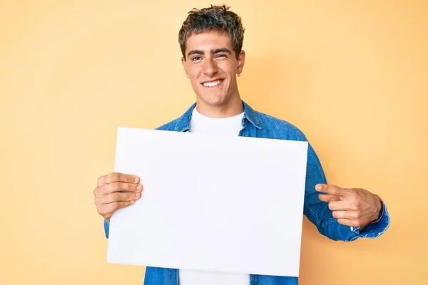 Young Handsome Man Holding Blank Empty Banner Winking Looking Camera — Stock Photo, Image