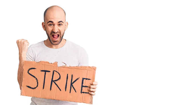 Young Handsome Man Holding Strike Banner Screaming Proud Celebrating Victory — Stock Photo, Image