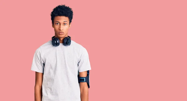 Young African American Man Wearing Gym Clothes Using Headphones Serious — Stock Photo, Image
