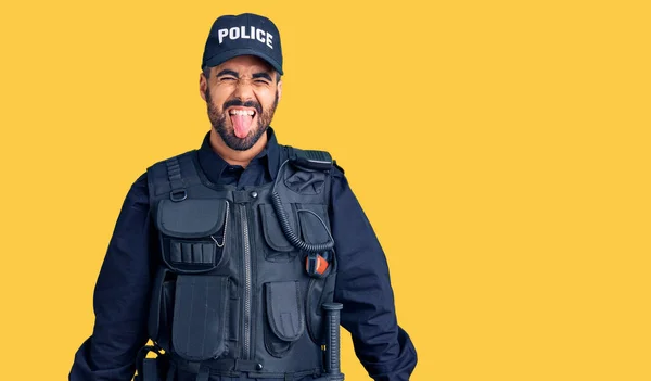 Young Hispanic Man Wearing Police Uniform Sticking Tongue Out Happy — Stock Photo, Image