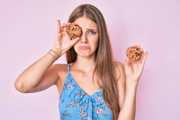 Young Blonde Girl Holding Cookie Depressed Worry Distress Crying Angry — Stock Photo, Image