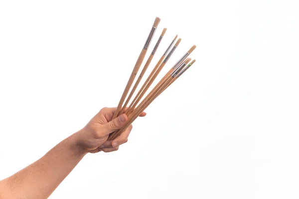 Hand Caucasian Young Man Holding Paintbrushes Isolated White Background — Stock Photo, Image