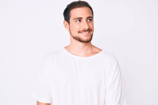 Young Handsome Man Wearing Casual White Tshirt Looking Away Side — Stock Photo, Image