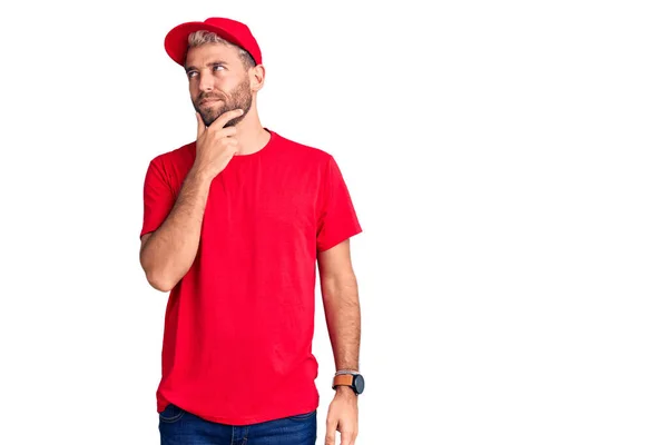 Joven Hombre Rubio Guapo Usando Camiseta Gorra Con Mano Barbilla —  Fotos de Stock