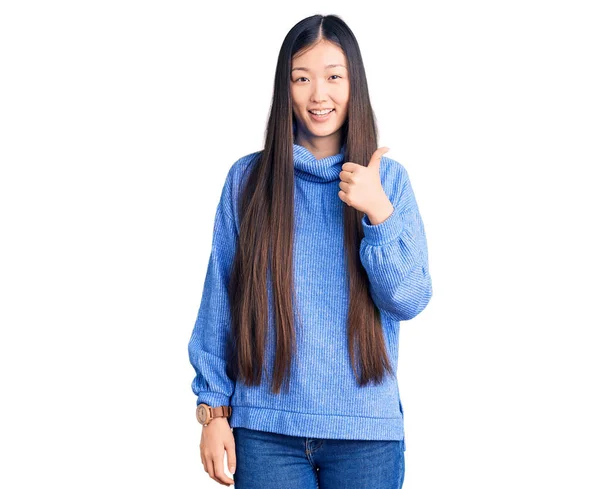 Młoda Piękna Chinka Ubrana Luźny Sweter Robiąca Gesty Ręką Górę — Zdjęcie stockowe