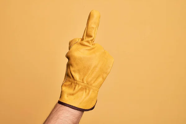 Hand Caucasian Young Man Gardener Glove Isolated Yellow Background Showing — Φωτογραφία Αρχείου