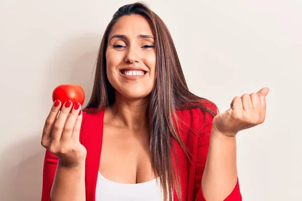 Young Beautiful Brunette Woman Holding Tomato Screaming Proud Celebrating Victory — Stock Photo, Image