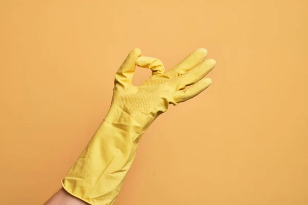 Hand Caucasian Young Man Cleaning Glove Isolated Yellow Background Gesturing — Stock Photo, Image
