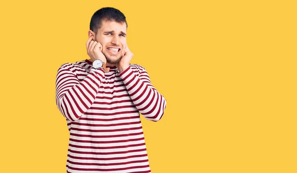 Young Handsome Man Wearing Striped Sweater Covering Ears Fingers Annoyed — Stock Photo, Image