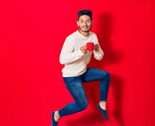 Young Handsome Latin Man Smiling Happy Drinking Cup Coffee Jumping — Stock Photo, Image