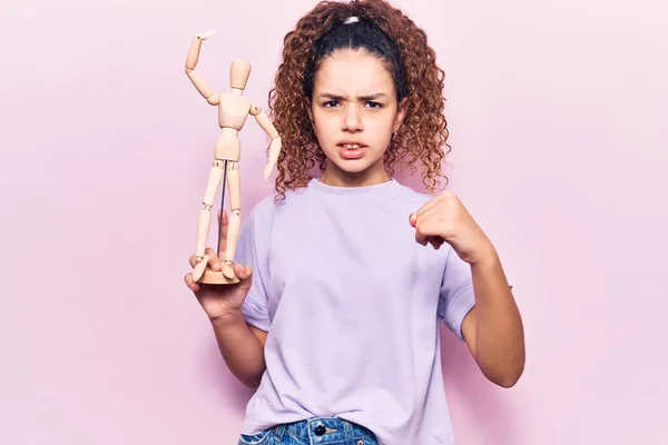 Beautiful Kid Girl Curly Hair Holding Small Wooden Manikin Annoyed — Stock Photo, Image