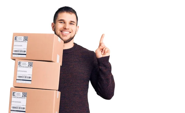 Young Handsome Man Holding Delivery Package Surprised Idea Question Pointing — Stock Photo, Image