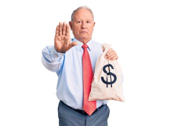 Kıdemli yakışıklı, gri saçlı, şık kıyafetler giyen, elinde para çantası olan, dur işareti yapan, ciddi ve kendinden emin bir ifade sergileyen, savunma jesti. 