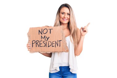 Genç, güzel, sarışın bir kadın elinde karton afişimi tutmuyor. Bir numaralı mutlu yüzle işaret eden bir fikre ya da soruya şaşırmış değilim. 