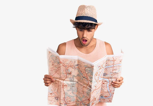 Joven Hombre Hispano Con Sombrero Verano Sosteniendo Mapa Asustado Sorprendido — Foto de Stock