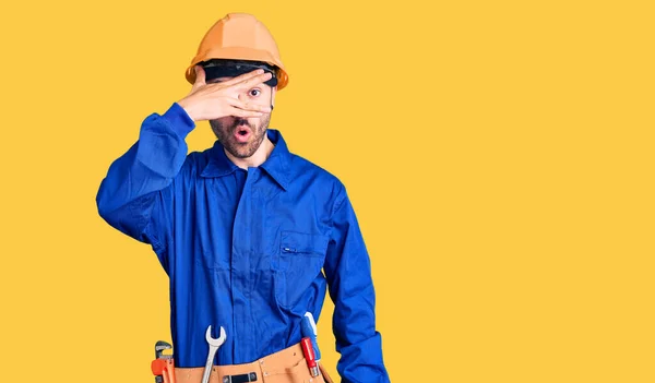 Joven Hombre Hispano Vistiendo Uniforme Obrero Asomándose Impactante Rostro Ojos —  Fotos de Stock