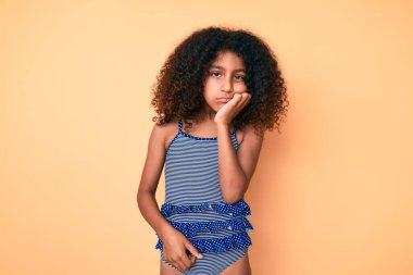 African american child with curly hair wearing swimwear thinking looking tired and bored with depression problems with crossed arms.  clipart