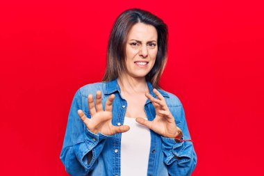 Genç ve güzel bir kadın günlük giysiler giyer, tiksindirici bir ifade takınır, hoşnutsuz ve korku dolu bir ifade takınır. Çünkü tiksinti tepkisi verir. Eller havada. 