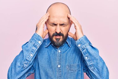 Stres yüzünden başı ağrıyan, sıradan kıyafetler giyen genç ve yakışıklı bir adam. migren ağrısı. 