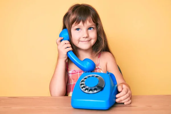 Pequeña Niña Caucásica Con Pelo Largo Sentado Mesa Usando Teléfono —  Fotos de Stock