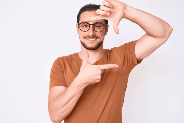 Homem Bonito Jovem Vestindo Roupas Casuais Óculos Sorrindo Fazendo Moldura — Fotografia de Stock