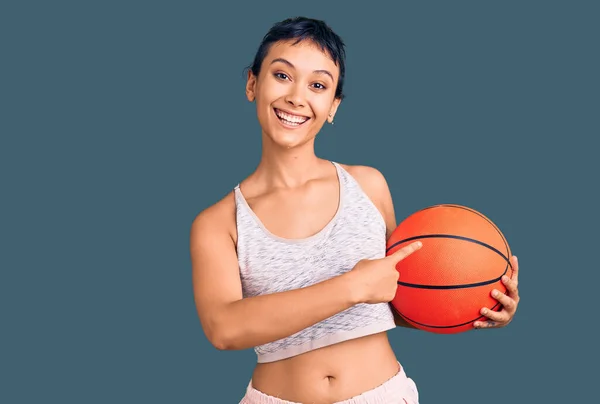 Mujer Joven Sosteniendo Pelota Baloncesto Sonriendo Feliz Señalando Con Mano —  Fotos de Stock