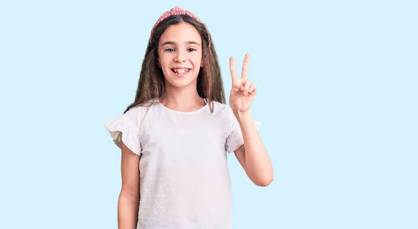 Cute Hispanic Child Girl Wearing Casual White Tshirt Showing Pointing — Stock Photo, Image