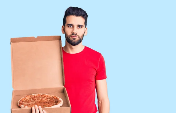 Young Handsome Man Beard Holding Delivery Cardboard Italian Pizza Thinking — Stock Photo, Image